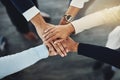 Hands stacked or piled to show team unity, strength or motivation among business men, women or colleagues from above Royalty Free Stock Photo