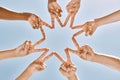 Hands, star and collaboration with a team of people standing in a huddle or circle with their fingers touching. Sky Royalty Free Stock Photo