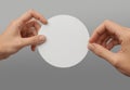 Hands sticking white round sticker, grey background, ai generated Royalty Free Stock Photo