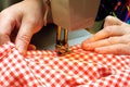 Hands stitching denim cloth with a sewing machine Royalty Free Stock Photo