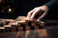 Hands stop dominoes, showcasing business risk control and insurance planning