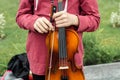 Hands of a street musician girl with violin close up Royalty Free Stock Photo