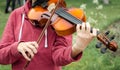 Hands of a street musician girl with violin close up Royalty Free Stock Photo