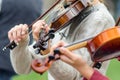 Hands of a street musician girl with violin close up Royalty Free Stock Photo