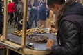 Hands of street vendor chestnuts. Roasted chestnuts in street vendors. Popular food among tourists and Turks. Istanbul, Turkey