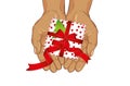 Hands stretch a gift box with a bow and a Christmas tree. View f