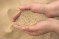 Hands strew sand