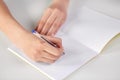 Hands of student girl with pen writing to notebook Royalty Free Stock Photo