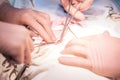 Hands of surgeon and assistant close-up during operation
