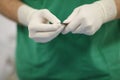 Hands of surgeon in latex protective gloves