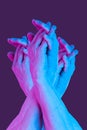 Hands in a surreal style in violet blue neon colors. Modern psychedelic creative element with human palm for posters