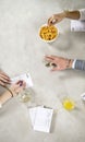 Hands on a table during a social game of dice