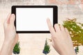 Hands with tablet with cutout screen and wall