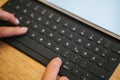 Hands on the tablet keyboard with German letters. The concept of remote work, freelancing, blogging, design and other