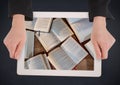 Hands with tablet on navy table showing open books Royalty Free Stock Photo