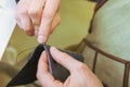 hands of a tailor seamstress in the production shop with a needle and thread in their hands, clothing production, hand sewing Royalty Free Stock Photo