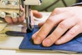 hands of a tailor seamstress at work in the shop for a sewing machine industrial, clothing production, loom