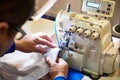 Hands of tailor and sewing machine Royalty Free Stock Photo