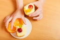 Hands take gourmet cream cake cookie and orange Royalty Free Stock Photo