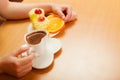 Hands take gourmet cream cake cookie and orange Royalty Free Stock Photo