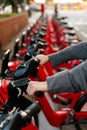 Hands taking a bike from a rental bicycle parking Royalty Free Stock Photo