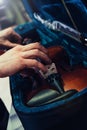 Hands taking or keeping save violin on its case. Blue velvet violin case Royalty Free Stock Photo