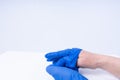 Hands taking off blue nitril gloves Royalty Free Stock Photo