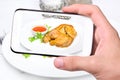 Hands taking photo chicken with smartphone