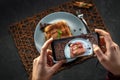 Hands taking photo homemade tiramisu cake with smartphone
