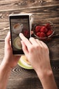 Hands taking photo pancakes with smartphone