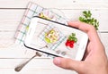 Hands taking photo radish salad with smartphone