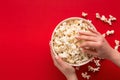 Bucket of popcorn on red background, top view Royalty Free Stock Photo