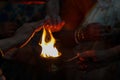 Hands taking warmth of Divine diya holy flame of hindu god worship puja for blessings Royalty Free Stock Photo