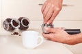 Hands tamp ground coffee with tamper on table Royalty Free Stock Photo