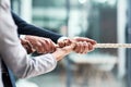 Hands, teamwork and rope with business people grabbing during a game of tug of war in the office. Collaboration, help or Royalty Free Stock Photo