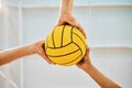 Hands, teamwork and water polo with sports people holding a ball in a gym for fitness or training from below. Exercise Royalty Free Stock Photo