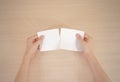 Hands tearing a piece of paper in half blank white flyer brochure booklet. Leaflet presentation. Pamphlet hold hands. Show clear