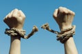 Hands tearing shackles the background of blue sky Royalty Free Stock Photo