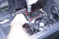 Hands of a technician assembling computer hardware parts new cpu is being mounted unto the motherboard Royalty Free Stock Photo