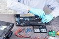 Hands of a technician repairing a broken laptop computer Royalty Free Stock Photo