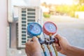 The hands of Technician are using a measuring tool to check Vacuum pump evacuates air Royalty Free Stock Photo