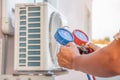 Hands of technician are using a measuring tool to check Vacuum pump evacuates air Royalty Free Stock Photo