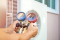 Hands of Technician are using a measuring tool to check vacuum pump evacuates air Royalty Free Stock Photo