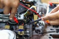 Hands of a technician using a multimeter to check the wiring and solenoid Royalty Free Stock Photo
