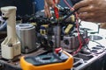Hands of a technician using a multimeter to check the wiring and solenoid Royalty Free Stock Photo