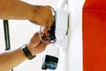 Hands of technician is working connecting power cords to install the CCTV on building wall