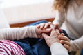 Hands of teenage girl and her grandmother at home. Royalty Free Stock Photo
