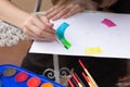 Hands of a teenage girl painting on a sheet a chromatic circle with watercolors and a brush. Royalty Free Stock Photo