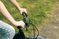 Hands of a teenager on the handlebars of a Bicycle.