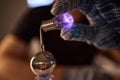 Hands test plasma, Detailed image of electrical discharge testing process, Precision testing of purple plasma arc by technician Royalty Free Stock Photo